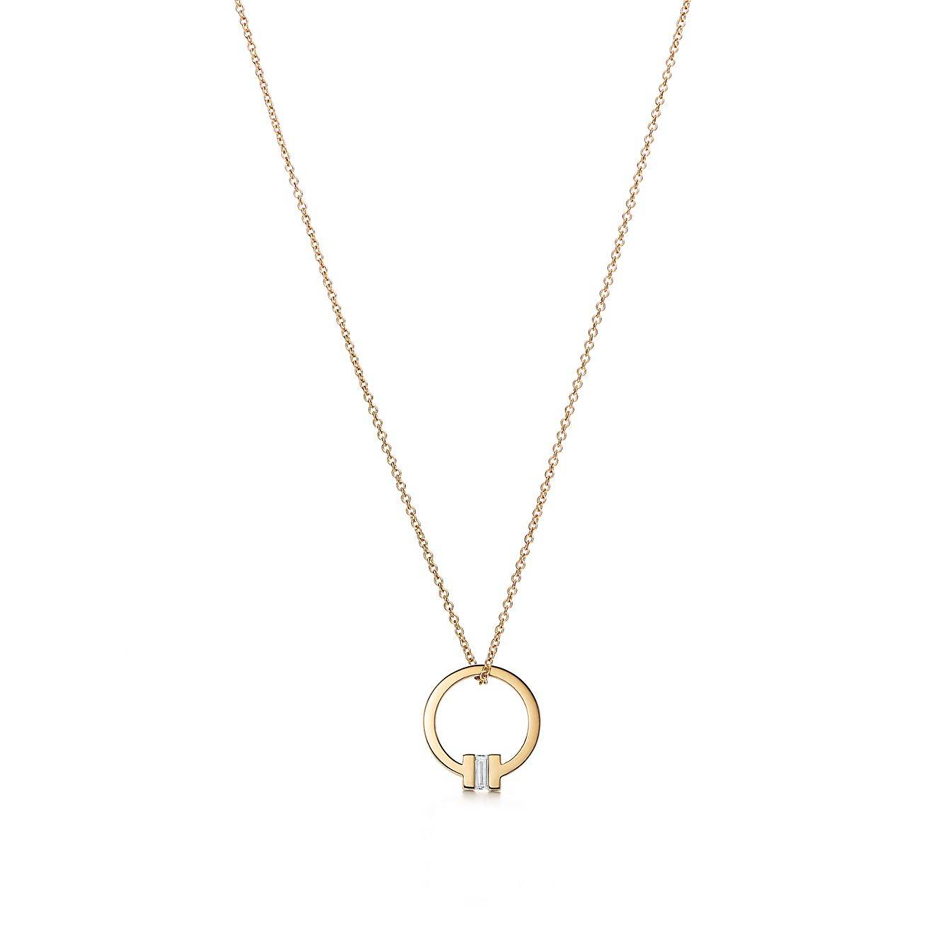 TIFFANY T PENDANT IN 18K GOLD WITH A BAGUETTE DIAMOND